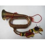 A bugle, with black red and yellow tassels
