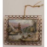 An enamel landscape panel, to an unmarked bead and wire frame, 5.3cm x 4.2cm