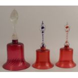 A pair of Victorian cranberry glass bells, with blue and red air twist handles, height 9ins,