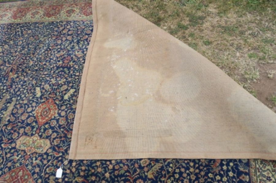 A large Eastern design rug, having a blue ground to a red border, decorated with foliage and - Image 4 of 4