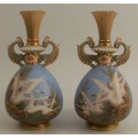 A pair of Royal Worcester vases, decorated with flying swans to a powder blue ground, by C H C