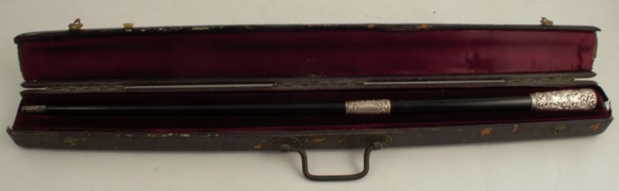A Victorian ebony and silver mounted baton, with embossed and engraved munts, in a fitted case,