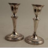A pair of modern hallmarked silver loaded candlesticks, height 8.25ins