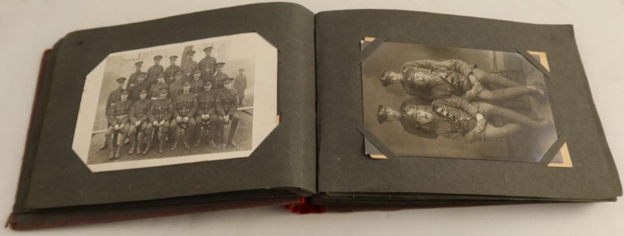 A postcard album, containing some WW1 cards, including one of a Zeppelin, plus assorted others