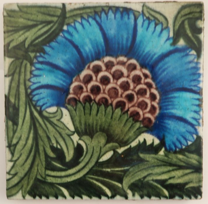 A William de Morgan tile, decorated with a radiating blue flower on a green foliate background, 6.