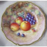 A Royal Worcester cabinet plate, decorated with fruit to a mossy background by H Aryton, with gilt