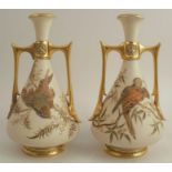 A pair of Royal Worcester Persian style two handled gilded ivory vases, decorated with shot silk