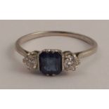 A three stone sapphire and diamond ring, the white mount stamped 'Plat', the square cut sapphire
