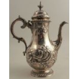 A Victorian silver coffee pot, of baluster form, with embossed decoration and C scroll handle,