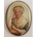 A miniature portrait on ceramic, the reverse monogrammed EM with 1913, the oval panel 6.5cm x 4.7cm