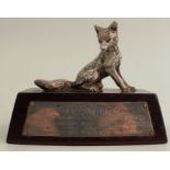 A silver model, of a seated fox, on base with silver presentation plaque, London 1965, height 4ins