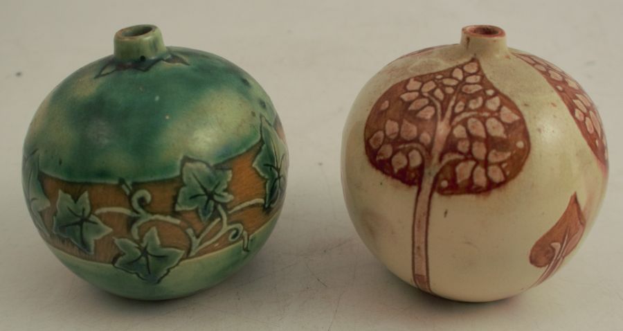 Two spherical vases, decorated with ivy and stylised flowers, monogrammed DRF to the base, height