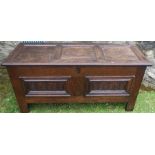 An Antique oak coffer, with fielded top, the front with carved panels and inlay, 54.5ins x 20ins,