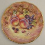 A Royal Worcester cabinet plate, decorated with fruit to a mossy background by D Fuller, with gilt