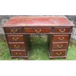A 19th century knee hole pedestal desk, fitted one long drawer, flanked by a short drawer to each