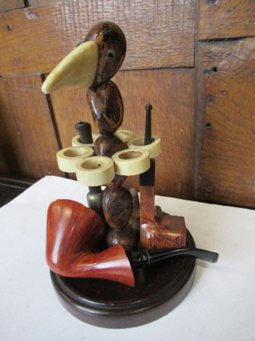 A 1930's Art Deco nut-bird pipe rack, along with five pipes, comprising an Art Deco B.B.B. square