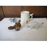 A pair of pottery whistles modelled as birds, together with another modelled as a rabbit, and a