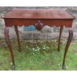 An Edwardian mahogany silver table, of rectangular form, with shaped apron and carved decoration,