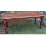 An antique pine kitchen table, fitted with an end drawer, raised on turned legs, 74ins x 31.5ins x