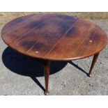 An antique oak gateleg dining table, of oval form, with swing leg action, raised on pad feet,