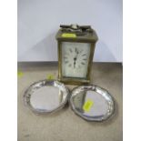 A brass cased carriage clock, together with a pair of Christofle France dishes