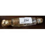 A double ended glass scent bottle, with gilt metal caps