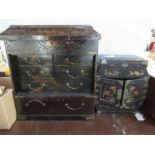 Two Oriental black lacquer table cabinets, fitted with drawers, with gilt decoration