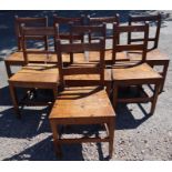 A matched set of eight oak solid seat dining chairs, with bar back, height 34.5ins x width 18.