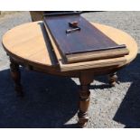 An oak extending dining table, raised on turned legs, with two leaves and winder, closed 55ins x