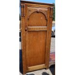 A reproduction oak hall cupboard, with carved decoration to the door, height 72ins x width 31ins x