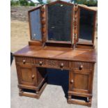 A reproduction oak dressing table, with three mirrors, fitted drawers and cupboards, width 49ins