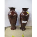 A pair of Eastern metal vases, of baluster form, decorated with birds, height 9ins