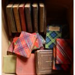 A box of miniature books, some with tartan covers