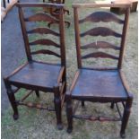A pair of antique elm chairs, with ladder back and solid seat
