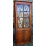 A 19th century mahogany floor standing corner cupboard, the upper section with a pair of glazed