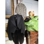 A collection of vintage clothing, to include two tail coats, one in black and white cheque, a pair