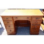 A 19th century mahogany dressing table/desk, fitted with an arrangement of nine drawers around the
