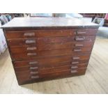 A stained pine plan chest, fitted eight drawers, width 48ins, height 36ins, depth 35ins