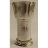 An Arts and Crafts style white metal beaker, engraved Amor Vincit Omnia to the flared foot, height