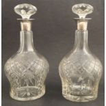 A pair of glass decanter, with hallmarked silver collars and glass stoppers, height 10.25ins