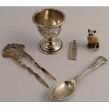 A collection of hallmarked silver, to include an egg cup, an ingot, a coffee spoon, a hair comb
