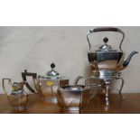 A silver four piece tea set, comprising spirit kettle on stand with burner, a tea pot, milk jug