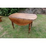 A fruitwood kitchen table