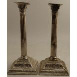 A pair of Victorian silver candlesticks, with Corinthian capitals to the fluted column, raised on