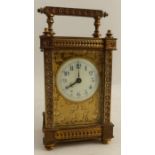 A gilt metal cased carriage clock, with enameled circular dial, the gilt front decorated with