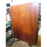 A 19th century mahogany rectangular topped breakfast tilt top table, raised on a column with four