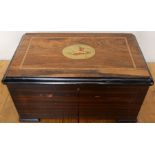 A Victorian rosewood cased table top musical box, the hinged lid decorated with a bird, the inside
