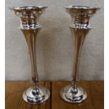 A pair of silver trumpet vases, with shaped edge, Chester 1924