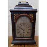 A Georgian mahogany cased bracket clock, the silvered arched dial inscribed John Wightwick,