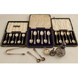 A cased set of six hallmarked silver tea spoons, together with two other sets of hallmarked silver